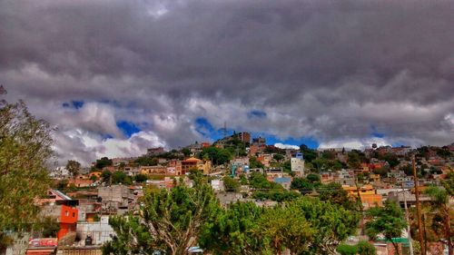 Panoramic view of residential district against cloudy sky