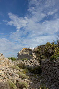 View of stone wall against cloudy sky