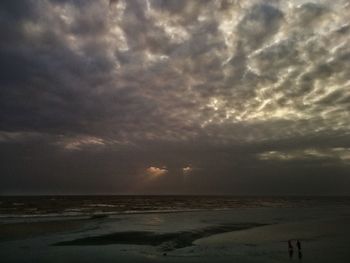 Scenic view of sea against storm clouds