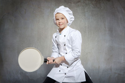 Portrait of girl standing in chef costume