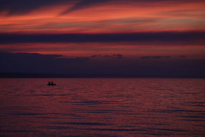 Scenic view of sea against orange sky