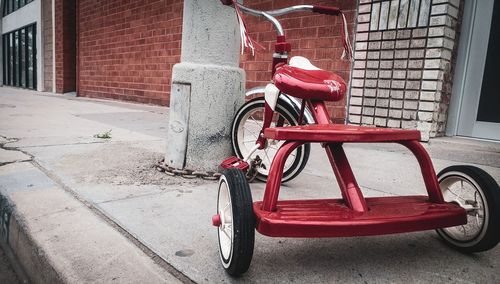 Bicycle parked on sidewalk by building