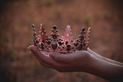 Close-up of woman holding crown.