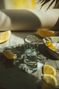 Low section of woman having drink on table