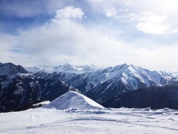 Scenic view of snowcapped mountains against sky