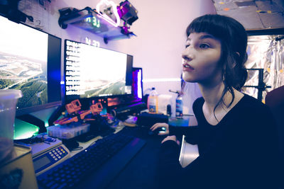 Portrait of young woman using laptop at cafe