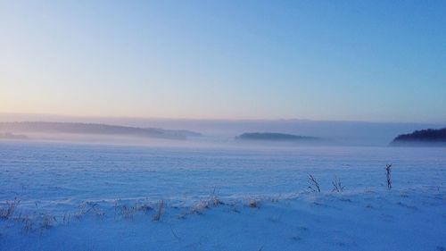 Scenic view of sea against clear sky during winter