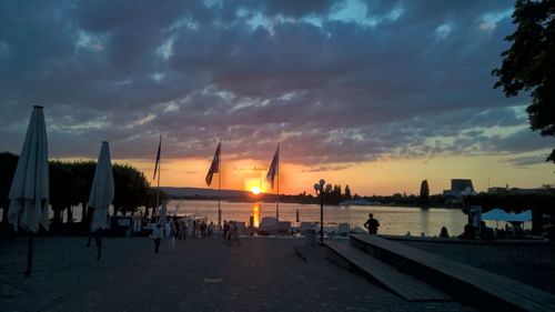 Scenic view of sea against cloudy sky at sunset