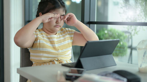 Young woman using laptop at office