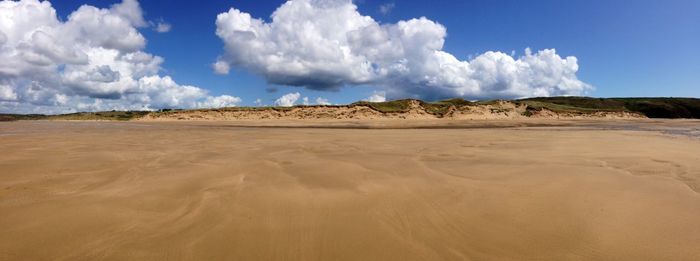 Scenic view of sandy desert against sky