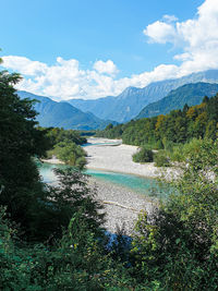 Scenic view of soca river against sky and hills