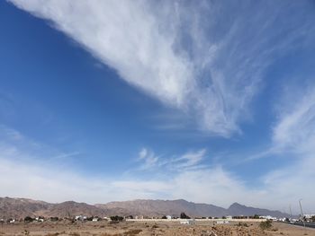 Scenic view of landscape against blue sky