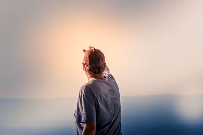 Rear view of woman standing against sea