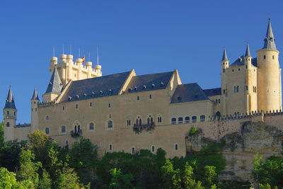 Low angle view of building against clear blue sky