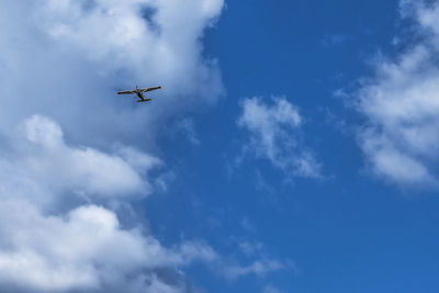 Low angle view of airplane flying in sky