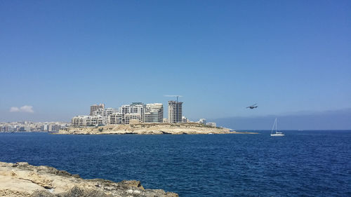 View of built structure by sea