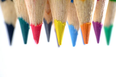 Close-up of multi colored pencils against white background
