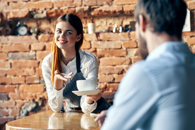 Cheerful colleagues sitting in cafe