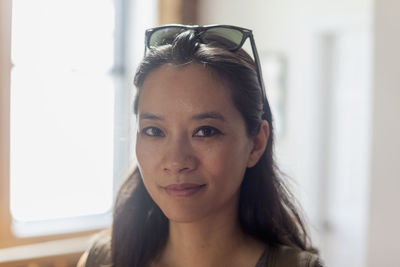 Portrait of young woman at home