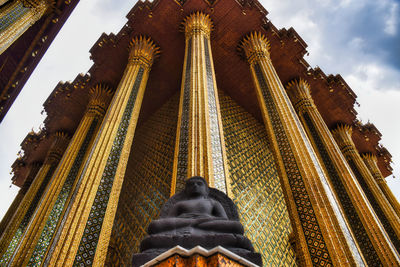 Low angle view of statue against temple building