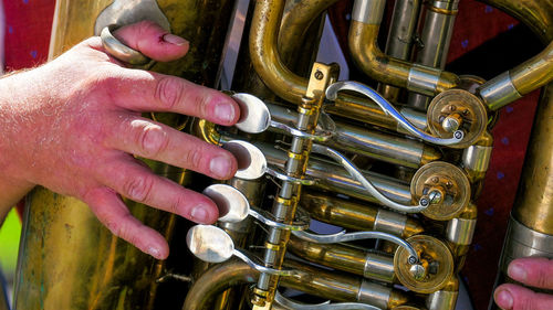 Cropped hand of man playing trumpet