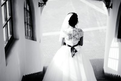 Rear view of bride moving down on steps