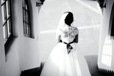 Rear view of woman standing with umbrella