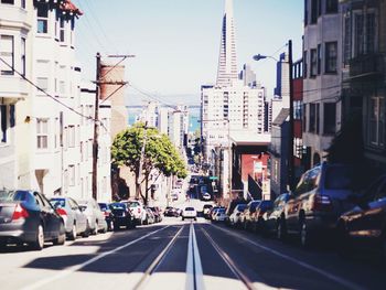 Cars on road amidst residential buildings