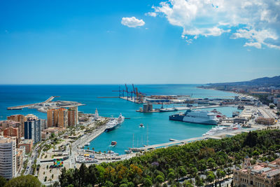 High angle view of cityscape by sea against sky