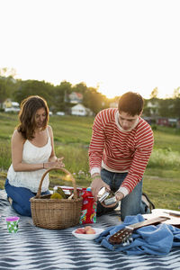 Couple enjoying picnic on field