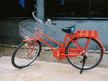 Side view of bicycle parked against building