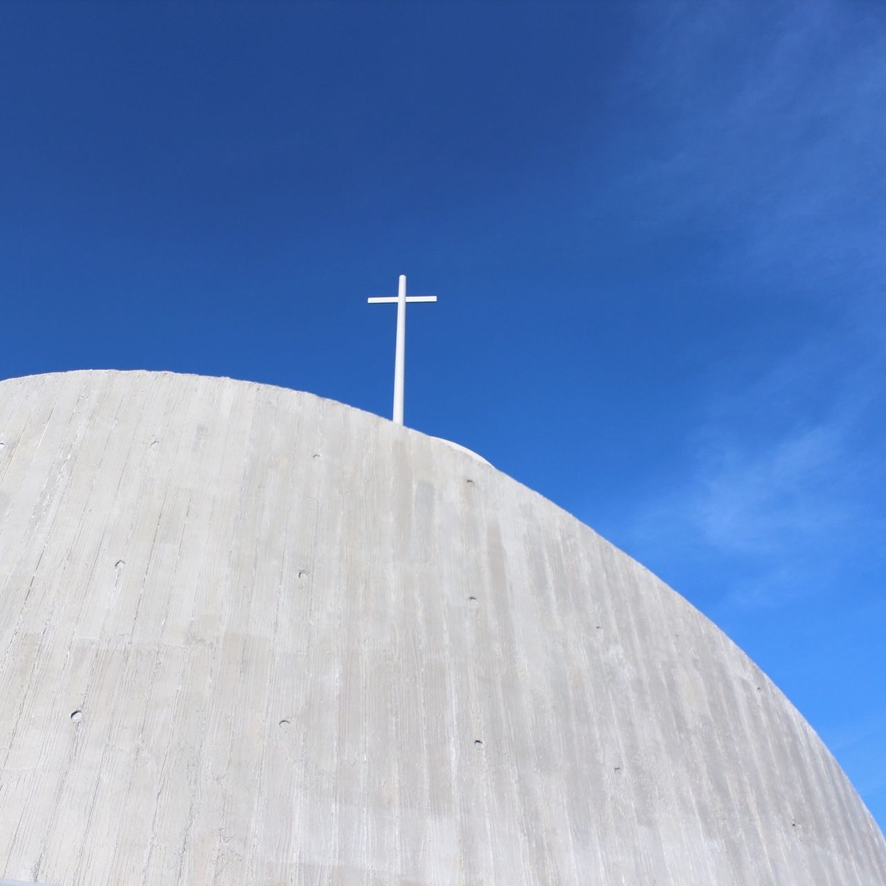 blue, low angle view, clear sky, copy space, wind power, alternative energy, cross, renewable energy, windmill, built structure, wind turbine, sky, environmental conservation, day, white color, fuel and power generation, outdoors, wood - material, street light, no people