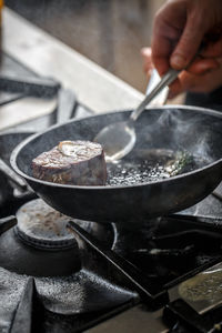 Cropped hand of man preparing food