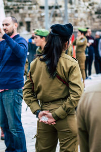 Rear view of people looking at city