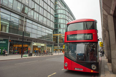 View of telephone booth on street against buildings in city