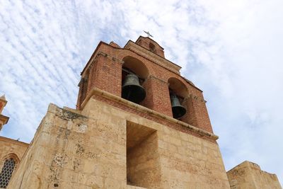 Low angle view of church against cloudy sky