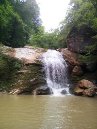 Scenic view of river flowing through rocks