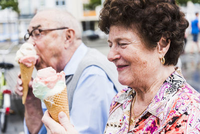 Smiling senior woman with ice cream cone