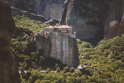 Scenic view of cliff by trees