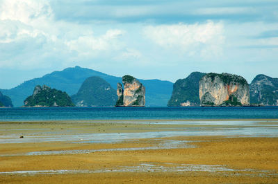 Scenic view of sea and mountains against sky