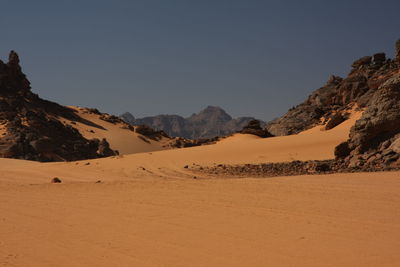 Scenic view of desert against clear sky acacus mountain, libya