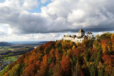 Panoramic view of trees and buildings against sky