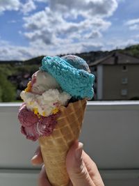 Close-up of hand holding ice cream cone