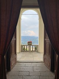 Entrance of building by sea against sky