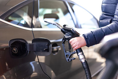 Midsection of man washing car