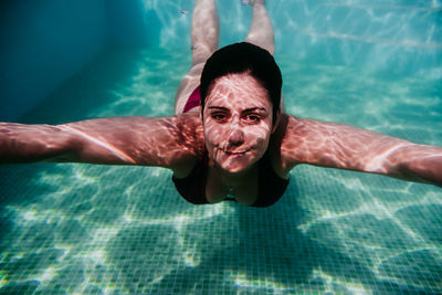 Portrait of man swimming in pool