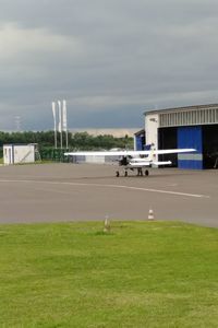 Airplane on airport runway against sky