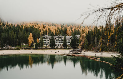 Scenic view of lake by trees against sky