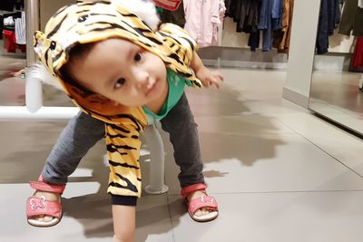 Full length of cute girl standing on floor at home