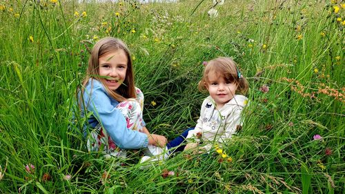 Portrait of mother and girl on field